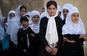 Kabul School girls wait for supplies handed out by NATO and Afghan forces. (Photo by G. A. Volb/Shutterjock)